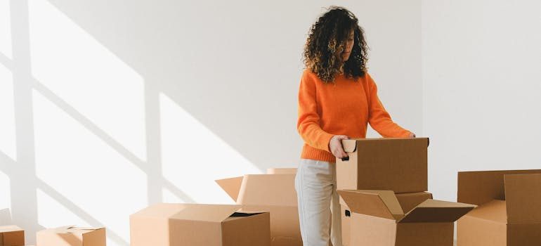 A woman packing and waiting for movers Redwood City CA