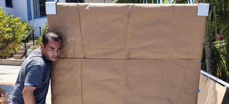 Movers carrying packed art