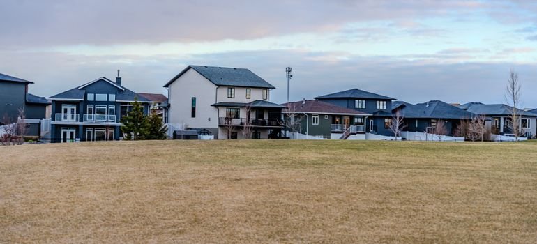 Newer two-story homes beside an open field in a planned community