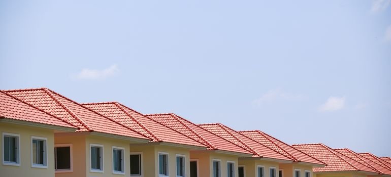 A row of identical pastel houses with matching roofs, similar to homes seen when moving to Westlake in Daly City