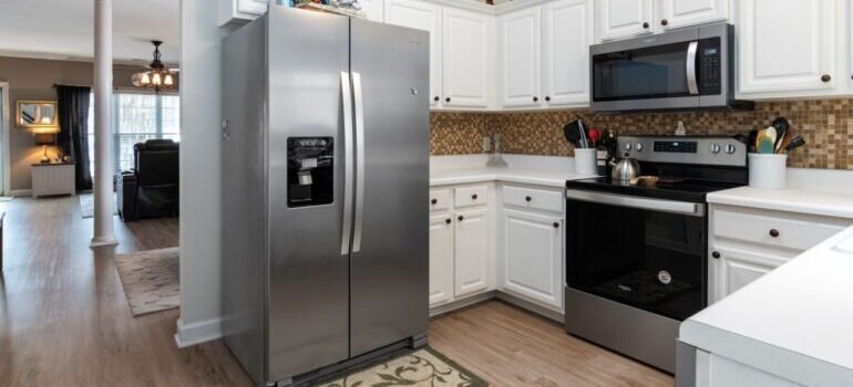 Bright kitchen showcasing stainless steel appliances and white cabinets.