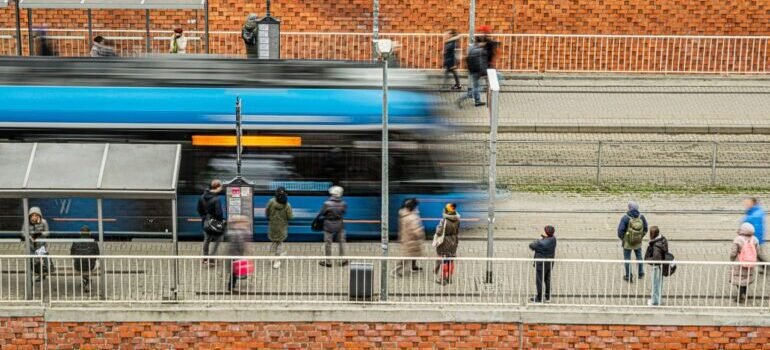 People waiting at a tram station, capturing urban daily life with motion blur.